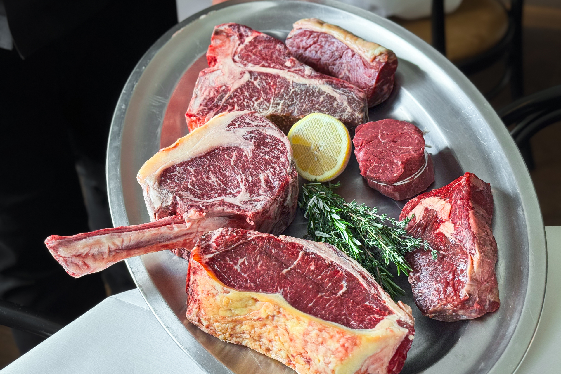 Selection of premium dry-aged steaks on a silver platter at The Grand